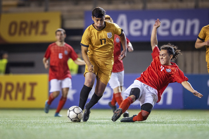 competitive-professional-soccer-player-aggressively-slide-tackles-toward-opposing-player-in-an-attempt-to-steal-ball