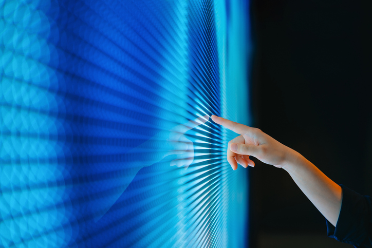 close-up-shot-of-a-female-hand-touching-illuminated-led-digital-display-screen-womans-finger-pointing-at-blue-coloured-digital-display-in-the-dark-connecting-to-the-future-futuristic-artificial-intelligence-innovation-and-technology-concept