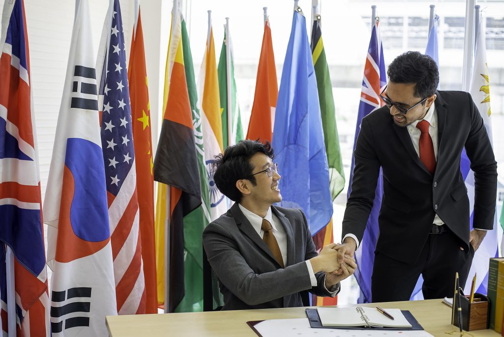 two-men-of-business-or-politicians-look-happy-and-shake-hand-to-show-the-cooperation-of-their-work-during-international-conference