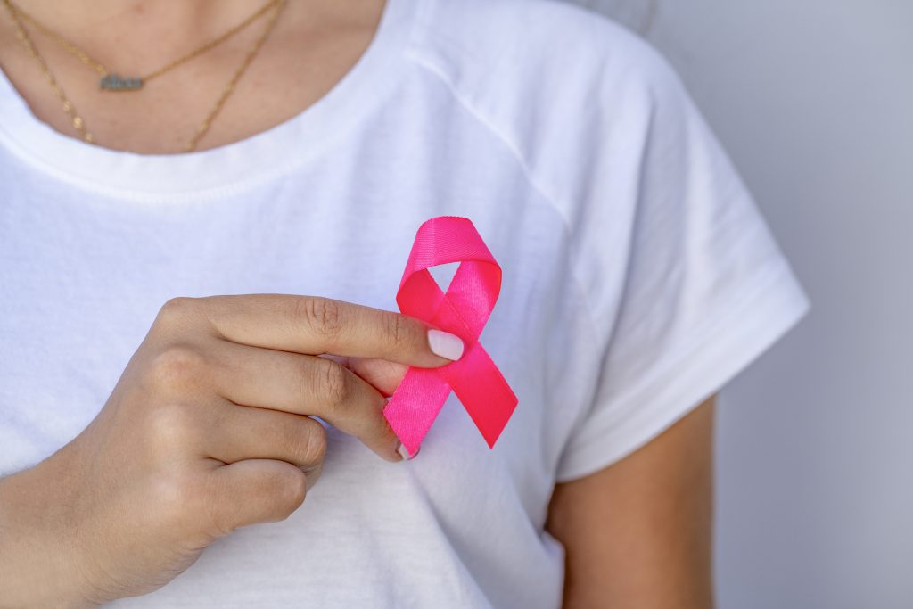 young-woman-with-pink-ribbon-on-a-white-background-mammary-cancer