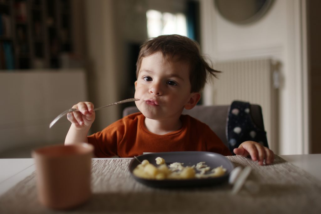 a-tres-year-old-little-boy-having-his-lunch-at-home