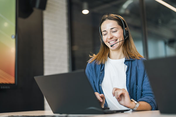 customer-service-happy-and-communication-of-woman-at-callcenter-desktop-talking-with-joyful-smile-consultant-advice-and-help-desk-girl-speaking-with-clients-online-with-computer-headset-mic-